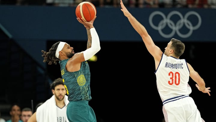 Aug 6, 2024; Paris, France; Australia guard Patty Mills (5) shoots the ball against Serbia point guard Aleksa Avramovic (30) during the second half in men’s basketball quarterfinals during the Paris 2024 Olympic Summer Games at Accor Arena. Mandatory Credit: Kyle Terada-USA TODAY Sports