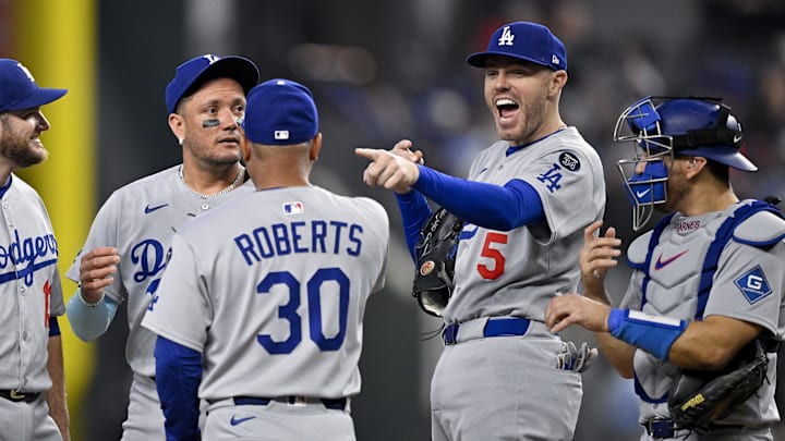 Arlington, Texas, USA; Los Angeles Dodgers first baseman Freddie Freeman (5) jokes with manager Dave Roberts (30) during the fifth inning against the Texas Rangers at Globe Life Field.