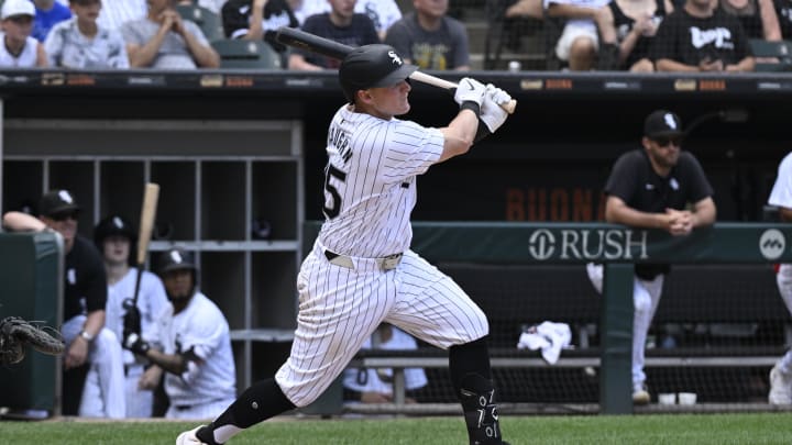 Jun 20, 2024; Chicago, Illinois, USA;  Chicago White Sox first base Andrew Vaughn (25) hits an RBI single against the Houston Astros during the fifth inning at Guaranteed Rate Field. Mandatory Credit: Matt Marton-USA TODAY Sports