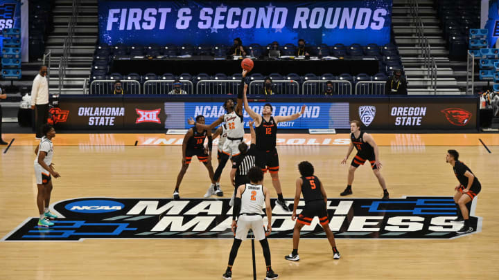 Mar 21, 2021; Indianapolis, Indiana, USA; Oklahoma State Cowboys forward Kalib Boone (22) and Oregon State Beavers center Roman Silva (12) tip off to start the first half in the second round of the 2021 NCAA Tournament at Hinkle Fieldhouse. Mandatory Credit: Patrick Gorski-USA TODAY Sports