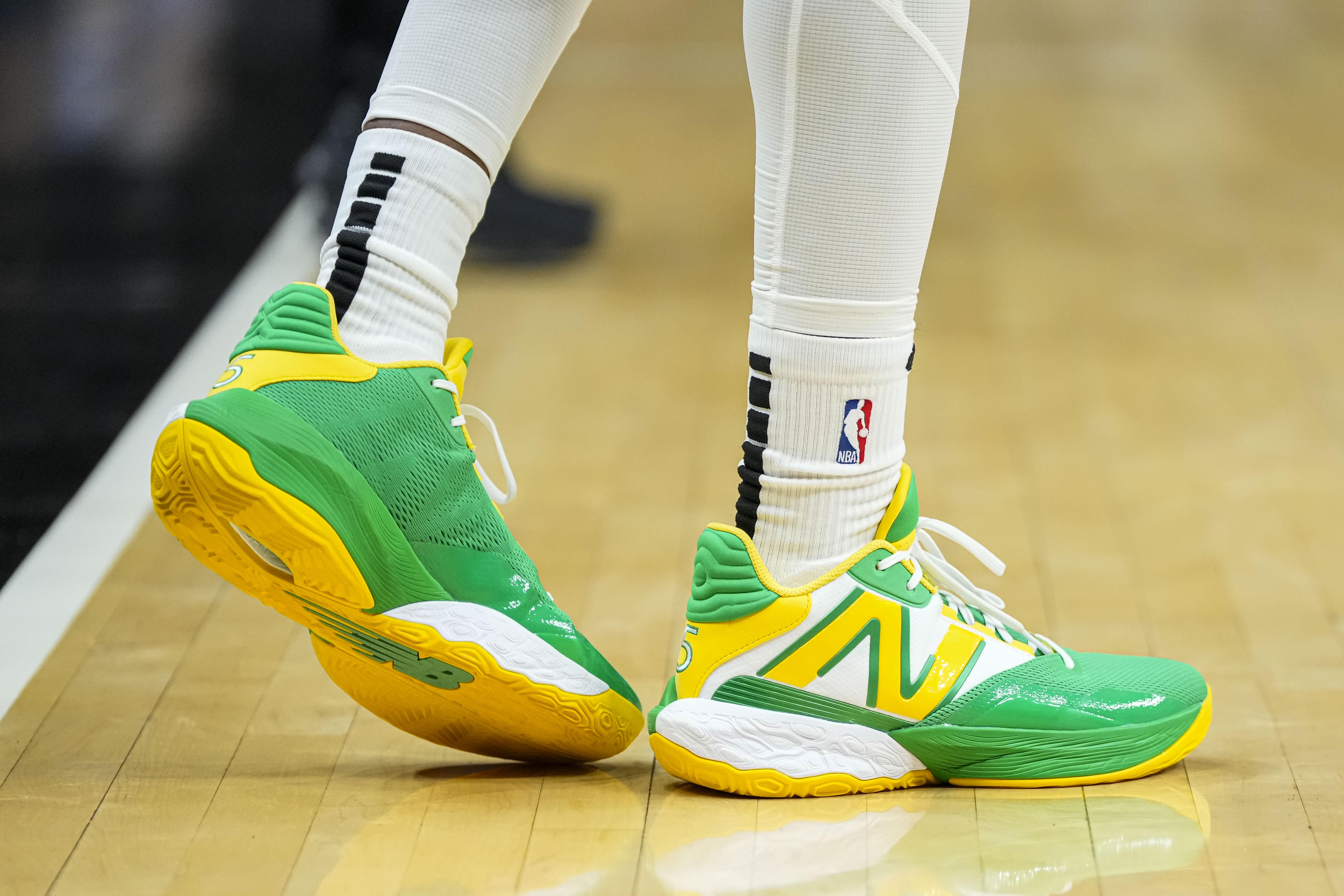 Atlanta Hawks guard Dejounte Murray's green and yellow New Balance sneakers.