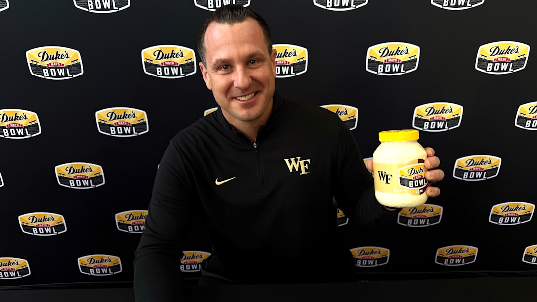 Wake Forest football head coach Jake Dickert holds a jar of Duke's Mayo after answering questions at the Duke's Mayo Bowl media day on Thursday. 