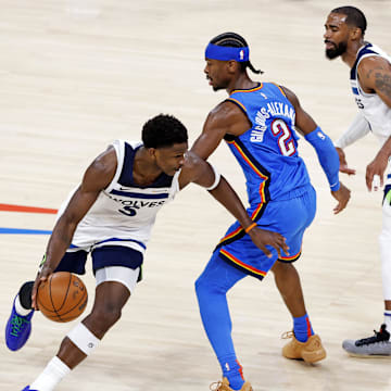 May 28, 2025; Oklahoma City, Oklahoma, USA; Minnesota Timberwolves guard Anthony Edwards (5) drives to the basket against Oklahoma City Thunder guard Shai Gilgeous-Alexander (2) during the third quarter in game five of the western conference finals for the 2025 NBA Playoffs at Paycom Center. Mandatory Credit: Alonzo Adams-Imagn Images