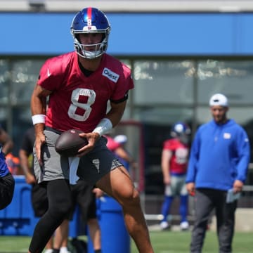 Jul 26, 2024; East Rutherford, NJ, USA; New York Giants quarterback Daniel Jones (8) fakes a handoff during training camp at Quest Diagnostics Training Center.  