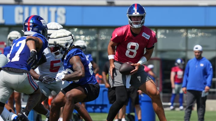 Jul 26, 2024; East Rutherford, NJ, USA; New York Giants quarterback Daniel Jones (8) fakes a handoff during Quest Diagnostics Training Center training camp. 