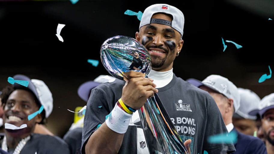 Philadelphia Eagles quarterback Jalen Hurts celebrates winning Super Bowl LIX while holding the Lombardi Trophy. | Michael Owens/Getty Images