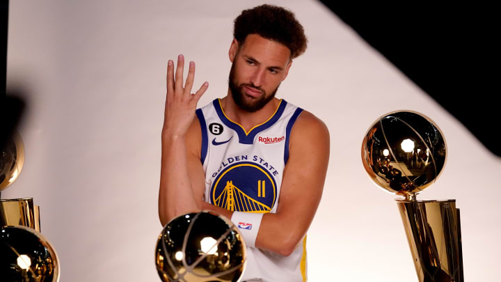 Sep 25, 2022; San Francisco, CA, USA; Golden State Warriors guard Klay Thompson (11) poses with the Larry O'Brien Championship Trophies during Media Day at the Chase Center. Mandatory Credit: Cary Edmondson-USA TODAY Sports