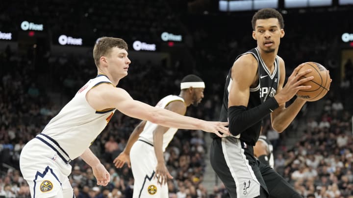 Apr 12, 2024; San Antonio, Texas, USA; San Antonio Spurs forward Victor Wembanyama (1) prepares to drive to the basket while defended by Denver Nuggets forward Christian Braun (0) during the first half at Frost Bank Center. Mandatory Credit: Scott Wachter-USA TODAY Sports