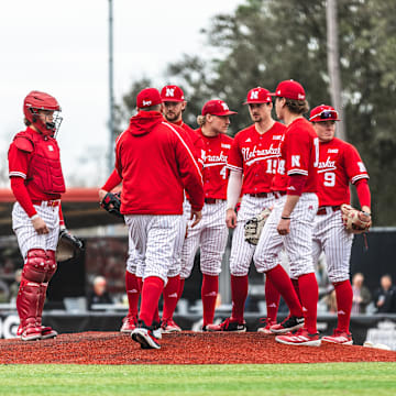 Nebraska baseball players meet on the mound during a game against Louisiana on Feb. 22, 2025.