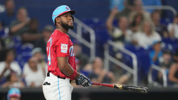 Jul 20, 2024; Miami, Florida, USA;  Miami Marlins designated hitter Bryan De La Cruz (14) strikes out with a man on third base against the New York Mets in the seventh inning at loanDepot Park. Mandatory Credit: Jim Rassol-USA TODAY Sports