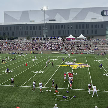 Vikings players warm up before the team's annual night practice.