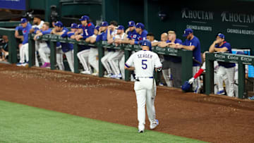 May 28, 2025; Arlington, Texas, USA; Texas Rangers designated hitter Corey Seager (5) walks back to the dugout after striking out during the ninth inning against the Toronto Blue Jays at Globe Life Field.