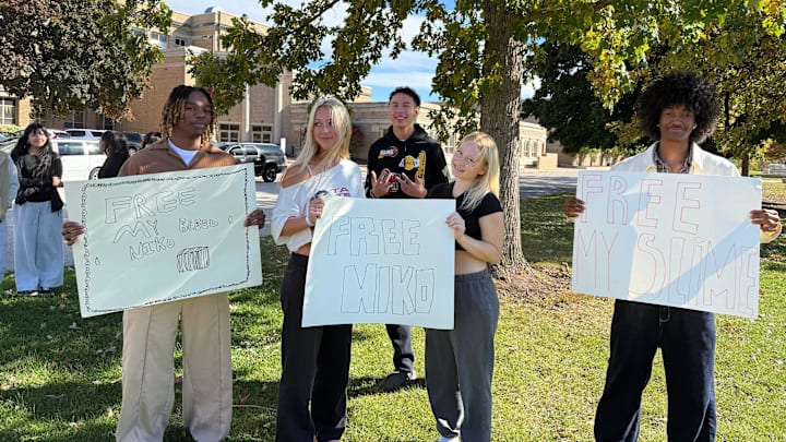 Green Bay East High School students Desmond Carr, Sara Shelton, Rose VanBeek and Tyrus Cooper pose with signs. Students protested football coach Niko Sila's administrative leave on Oct. 20. Green Bay East High School students Desmond Carr, Sara Shelton, Rose VanBeek and Tyrus Cooper pose with signs. Students protested football coach Niko Sila's administrative leave on Oct. 20.