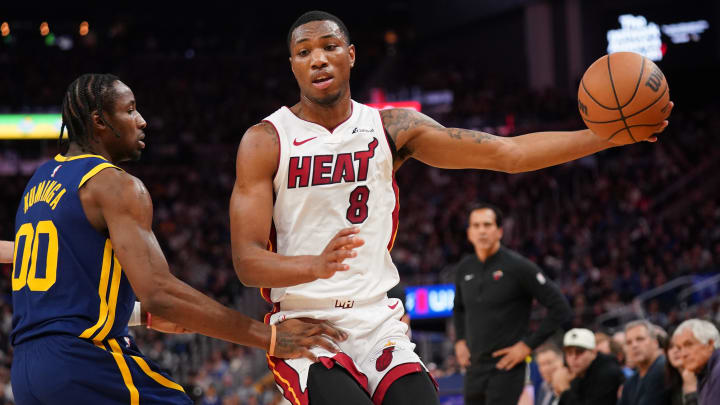 Dec 28, 2023; San Francisco, California, USA; Miami Heat forward Jamal Cain (8) holds onto the ball next to Golden State Warriors forward Jonathan Kuminga (00) in the fourth quarter at the Chase Center.