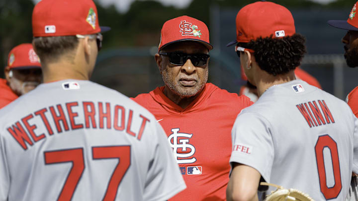 Feb 16, 2026; Jupiter, FL, USA;  St. Louis Cardinals hall of fame Ozzie Smith (middle) talks with infielders Masyn Winn (0) and JJ Wetherholt (77) during spring training workouts at Roger Dean Stadium. Mandatory Credit: Reinhold Matay-Imagn Images