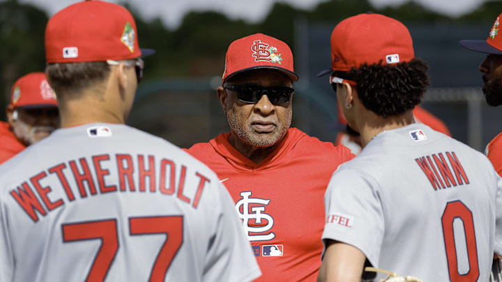 Feb 16, 2026; Jupiter, FL, USA;  St. Louis Cardinals hall of fame Ozzie Smith (middle) talks with infielders Masyn Winn (0) and JJ Wetherholt (77) during spring training workouts at Roger Dean Stadium. Mandatory Credit: Reinhold Matay-Imagn Images