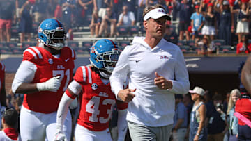Oct 11, 2025; Oxford, Mississippi, USA; Mississippi Rebels head coach Lane Kiffin leads his team out of the tunnel prior to the game against the Washington State Cougars at Vaught-Hemingway Stadium. Mandatory Credit: Petre Thomas-Imagn Images