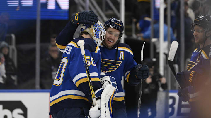 Apr 27, 2025; St. Louis, Missouri, USA; St. Louis Blues center Robert Thomas (18) and goaltender Jordan Binnington (50) celebrate defeating the Winnipeg Jets in game four of the first round of the 2025 Stanley Cup Playoffs at Enterprise Center. Mandatory Credit: Jeff Le-Imagn Images