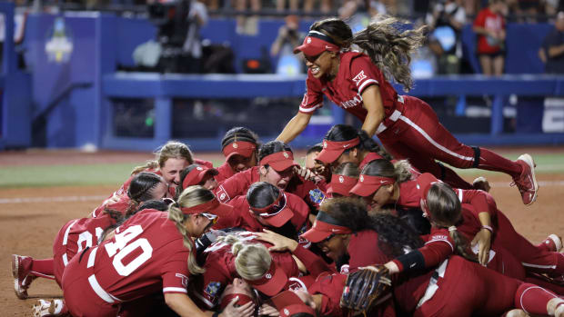 Oklahoma players celebrate after winning the softball championship for the fourth straight season.