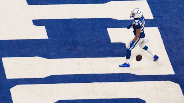 Colts running back Jonathan Taylor (blue and white uniform) enters the end zone for a touchdown.