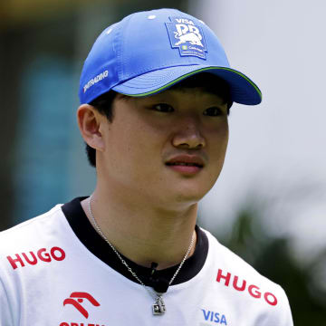 May 2, 2024; Miami Gardens, Florida, USA; RB racing driver Yuki Tsunoda (22) walks into the team village in advance of the F1 Miami Grand Prix at the Miami International Autodrome. Mandatory Credit: Peter Casey-USA TODAY Sports