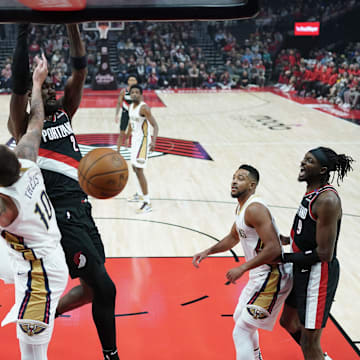 Oct 25, 2024; Portland, Oregon, USA; Portland Trail Blazers center Deandre Ayton (2) dunks the ball over New Orleans Pelicans center Daniel Theis (10) during the first half at Moda Center. Mandatory Credit: Soobum Im-Imagn Images