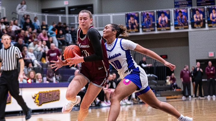 Dowling’s Katie Muller (11) drives past Johnston's Jenica Lewis (10) on Dec. 16, 2025, at Johnston High School. Dowling’s Katie Muller (11) drives past Johnston's Jenica Lewis (10) on Dec. 16, 2025, at Johnston High School.
