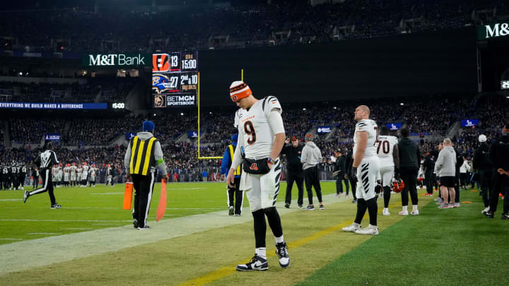 Injured Cincinnati Bengals quarterback Joe Burrow (9) paces the sideline in the fourth quarter of