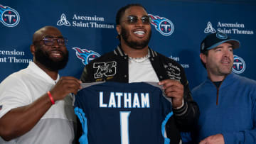 The Tennessee Titans first-round draft pick JC Latham poses with his new Titans jersey and General Manager Ran Carthon, left, and Head Coach Brian Callahan, right, at the teamÕs Ascension Saint Thomas Sports Park facility in Nashville, Tenn., Friday afternoon, April 26, 2024. The tackle was the No. 7 overall pick in the 2024 NFL Draft