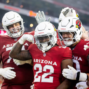 Aug 10, 2024; Glendale, Arizona, USA; Arizona Cardinals running back Michael Carter (22) celebrates with teammates after scoring a touchdown against the New Orleans Saints during a preseason NFL game at State Farm Stadium. Mandatory Credit: Mark J. Rebilas-USA TODAY Sports