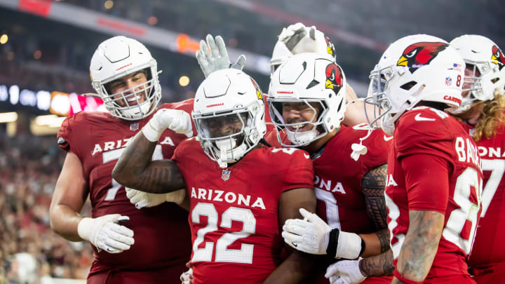 Aug 10, 2024; Glendale, Arizona, USA; Arizona Cardinals running back Michael Carter (22) celebrates with teammates after scoring a touchdown against the New Orleans Saints during a preseason NFL game at State Farm Stadium. Mandatory Credit: Mark J. Rebilas-USA TODAY Sports