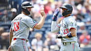 Aug 3, 2025; Cleveland, Ohio, USA; Minnesota Twins third baseman Royce Lewis (23) celebrates after scoring with right fielder Matt Wallner (38) during the first inning against the Cleveland Guardians at Progressive Field.
