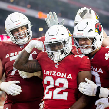 Aug 10, 2024; Glendale, Arizona, USA; Arizona Cardinals running back Michael Carter (22) celebrates with teammates after scoring a touchdown against the New Orleans Saints during a preseason NFL game at State Farm Stadium. Mandatory Credit: Mark J. Rebilas-Imagn Images