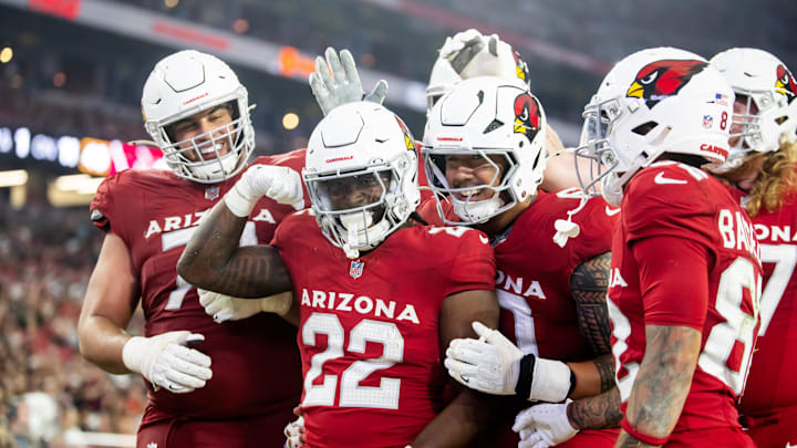 Aug 10, 2024; Glendale, Arizona, USA; Arizona Cardinals running back Michael Carter (22) celebrates with teammates after scoring a touchdown against the New Orleans Saints during a preseason NFL game at State Farm Stadium. Mandatory Credit: Mark J. Rebilas-Imagn Images