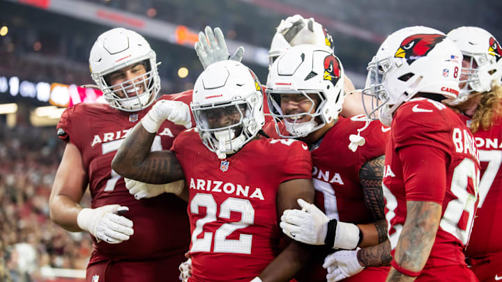 Aug 10, 2024; Glendale, Arizona, USA; Arizona Cardinals running back Michael Carter (22) celebrates with teammates after scoring a touchdown against the New Orleans Saints during a preseason NFL game at State Farm Stadium. Mandatory Credit: Mark J. Rebilas-Imagn Images