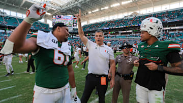 Nov 23, 2024; Miami Gardens, Florida, USA; Miami Hurricanes head coach Mario Cristobal celebrates with Miami Hurricanes offensive lineman Francis Mauigoa (61) and tight end Elijah Arroyo (8) after the game against the Wake Forest Demon Deacons at Hard Rock Stadium. Mandatory Credit: Sam Navarro-Imagn Images