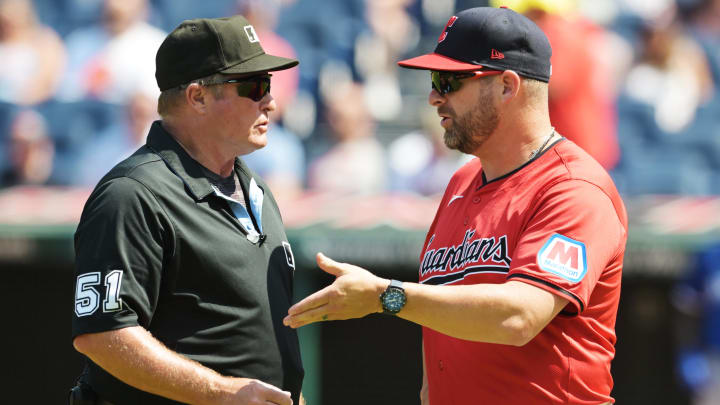 Aug 26, 2024; Cleveland, Ohio, USA; Cleveland Guardians manager Stephen Vogt (12) talks with umpire Marvin Hudson during the fourth inning against the Cleveland Guardians at Progressive Field. Mandatory Credit: Ken Blaze-USA TODAY Sports