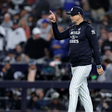Oct 29, 2024; New York, New York, USA; New York Yankees manager Aaron Boone (17) makes a pitching change during the fifth inning against the Los Angeles Dodgers in game four of the 2024 MLB World Series at Yankee Stadium. Mandatory Credit: Brad Penner-Imagn Images