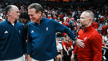 Kansas Jayhawks head coach Bill Self greets Louisville Cardinals head coach Pat Kelsey before the start of the exhibition game at the KFC Yum! Center in Louisville, Kentucky Friday, October 24, 2025.