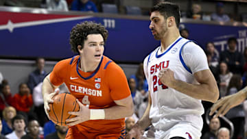Feb 22, 2025; Dallas, Texas, USA; Clemson Tigers forward Ian Schieffelin (4) looks to move the ball past SMU Mustangs center Samet Yigitoglu (24) during the first half at Moody Coliseum. Mandatory Credit: Jerome Miron-Imagn Images