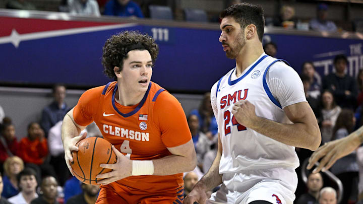 Feb 22, 2025; Dallas, Texas, USA; Clemson Tigers forward Ian Schieffelin (4) looks to move the ball past SMU Mustangs center Samet Yigitoglu (24) during the first half at Moody Coliseum. Mandatory Credit: Jerome Miron-Imagn Images