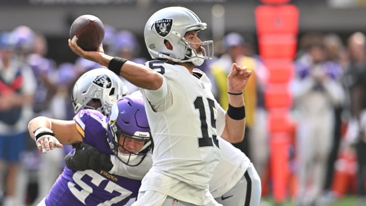 Aug 10, 2024; Minneapolis, Minnesota, USA; Las Vegas Raiders quarterback Gardner Minshew (15) throws a pass as Minnesota Vikings linebacker Owen Porter (57) pursues and offensive tackle Thayer Munford Jr. (rear) blocks during the second quarter at U.S. Bank Stadium. Mandatory Credit: Jeffrey Becker-USA TODAY Sports