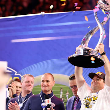 Dec 29, 2023; Arlington, TX, USA; Missouri Tigers head coach Eliah Drinkwitz holds up the Cotton Bow Trophy after the game against the Ohio State Buckeyes at AT&T Stadium. Mandatory Credit: Tim Heitman-Imagn Images