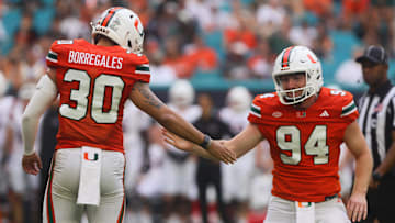 Sep 14, 2024; Miami Gardens, Florida, USA; Miami Hurricanes place kicker Andres Borregales (30) celebrates with holder Dylan Joyce (94) after kicking a field goal against the Ball State Cardinals during the first quarter at Hard Rock Stadium. Mandatory Credit: Sam Navarro-Imagn Images