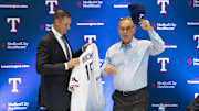 Texas Rangers general manager Chris Young presents new team manager Bruce Bochy his Rangers jersey and cap during a news conference at Globe Life Field. 