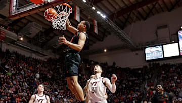 Jan 13, 2024; Blacksburg, Virginia, USA; Miami Hurricanes guard Matthew Cleveland (0) dunks the ball against Virginia Tech Hokies forward Robbie Beran (31) during the first half at Cassell Coliseum. Mandatory Credit: Peter Casey-Imagn Images