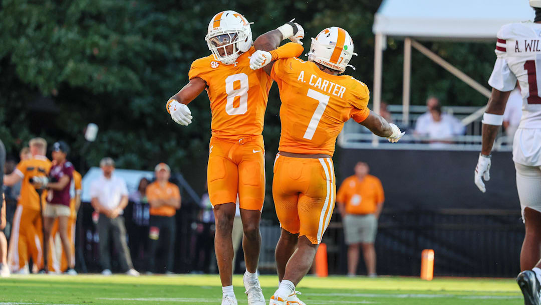 Sep 27, 2025; Starkville, Mississippi, USA; Tennessee Volunteers defensive back Colton Hood (8) and linebacker Arion Carter (7) celebrate after a defensive stop against the Mississippi State Bulldogs during the second half at Davis Wade Stadium at Scott Field. Mandatory Credit: Wesley Hale-Imagn Images
