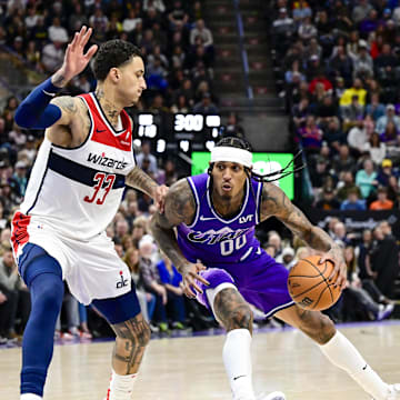 Mar 4, 2024; Salt Lake City, Utah, USA; Utah Jazz guard Jordan Clarkson (00) spins around Washington Wizards forward Kyle Kuzma (33) during the second half at the Delta Center. Mandatory Credit: Christopher Creveling-Imagn Images