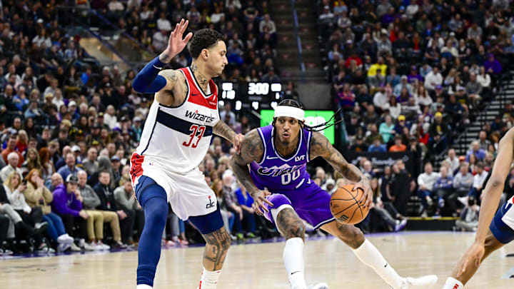 Mar 4, 2024; Salt Lake City, Utah, USA; Utah Jazz guard Jordan Clarkson (00) spins around Washington Wizards forward Kyle Kuzma (33) during the second half at the Delta Center. Mandatory Credit: Christopher Creveling-Imagn Images