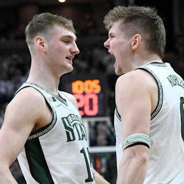 Feb 8, 2025; East Lansing, Michigan, USA; Michigan State Spartans forward Jaxon Kohler (0) and Michigan State Spartans center Carson Cooper (15) celebrate during the second half at Jack Breslin Student Events Center. Mandatory Credit: Dale Young-Imagn Images